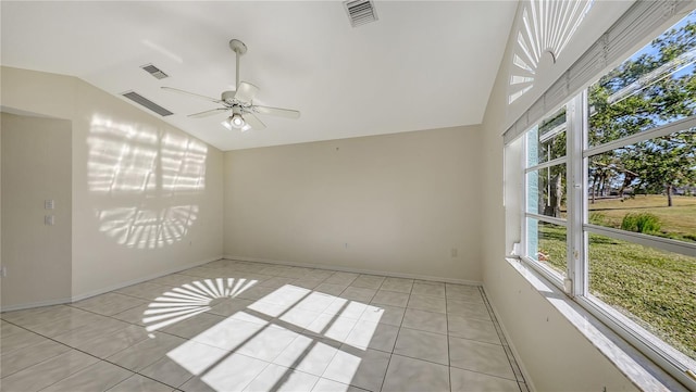 tiled empty room featuring ceiling fan and lofted ceiling