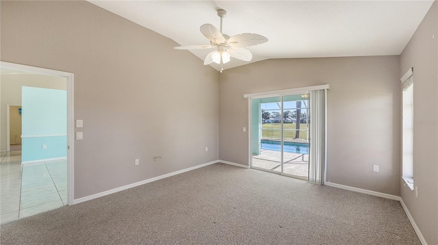 carpeted spare room featuring ceiling fan and vaulted ceiling