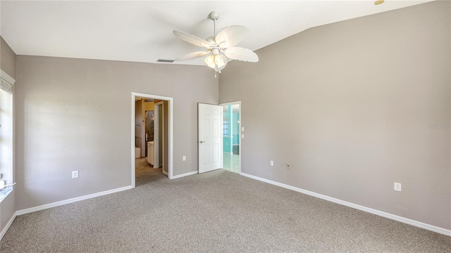 unfurnished bedroom with multiple windows, carpet floors, vaulted ceiling, and ceiling fan