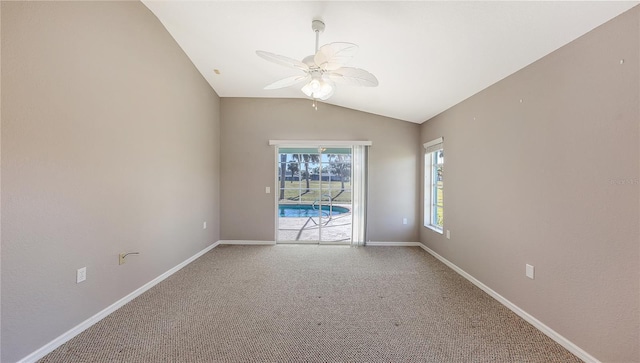 empty room with carpet, ceiling fan, and vaulted ceiling