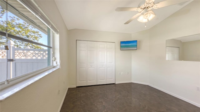 unfurnished bedroom featuring ceiling fan, a closet, and vaulted ceiling