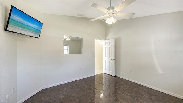 spare room with ceiling fan and high vaulted ceiling