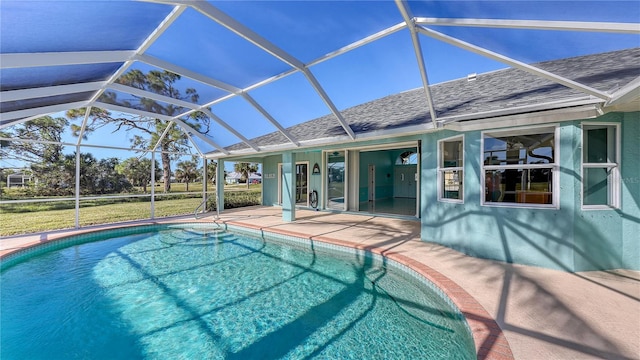 view of swimming pool with glass enclosure and a patio area