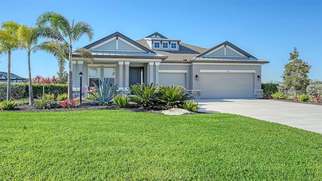 view of front of home with a garage and a front lawn