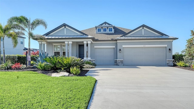 view of front of house featuring a garage and a front yard