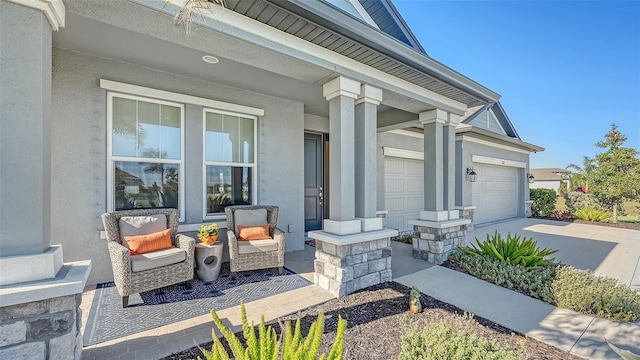 doorway to property with a porch and a garage