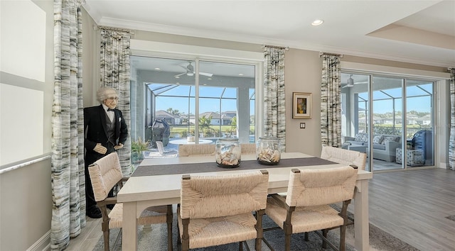 dining space featuring hardwood / wood-style flooring, ceiling fan, a healthy amount of sunlight, and crown molding