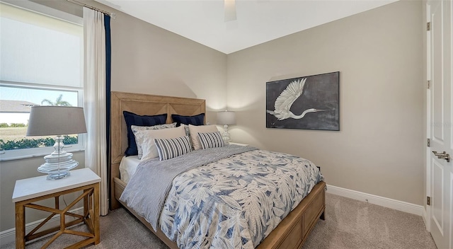 bedroom featuring ceiling fan and light colored carpet