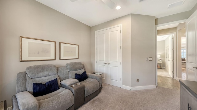 sitting room with light carpet and lofted ceiling