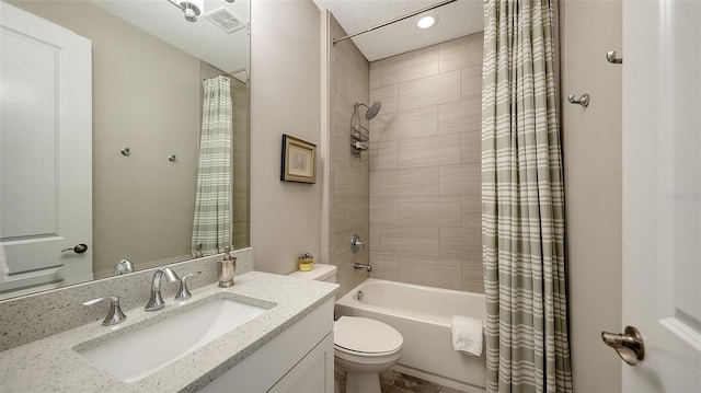 full bathroom featuring shower / tub combo with curtain, vanity, and toilet