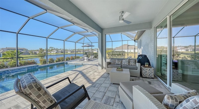 view of swimming pool featuring a lanai, outdoor lounge area, pool water feature, ceiling fan, and a patio area