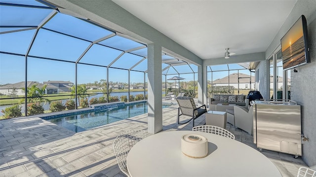 view of swimming pool with glass enclosure, ceiling fan, and a patio area