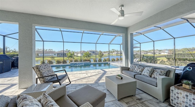 view of patio featuring outdoor lounge area, ceiling fan, glass enclosure, a jacuzzi, and grilling area