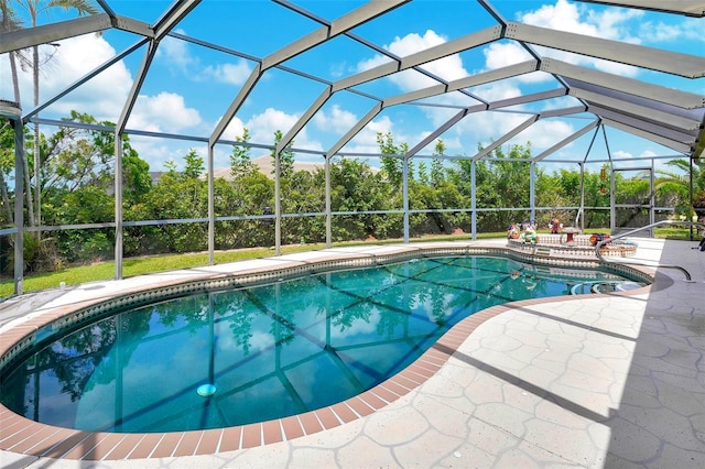 view of pool featuring a patio and glass enclosure