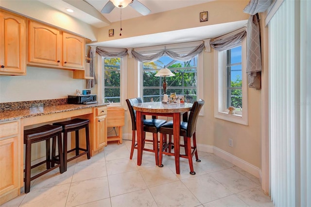 dining area featuring light tile patterned floors and ceiling fan