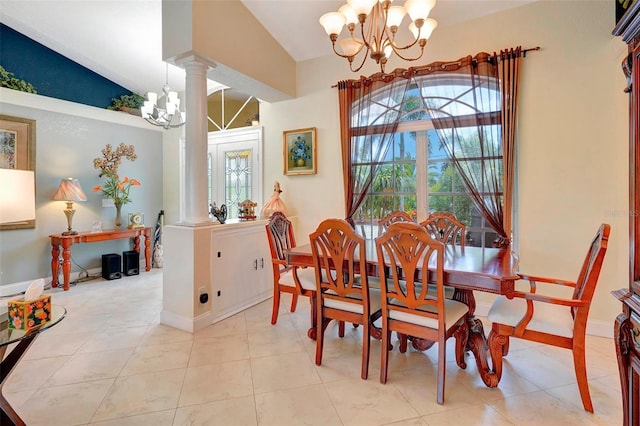 tiled dining room featuring a notable chandelier, lofted ceiling, and decorative columns