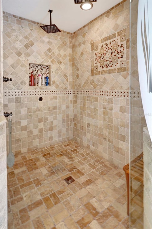 bathroom with tiled shower