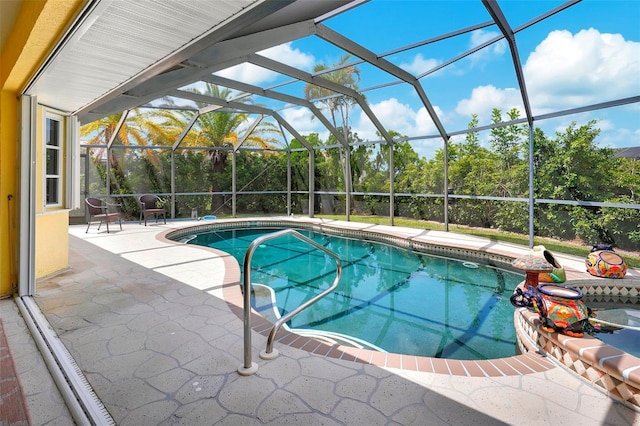 view of pool featuring glass enclosure and a patio