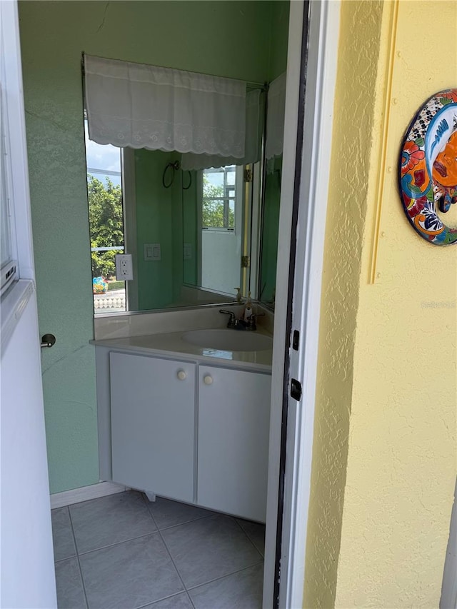 bathroom featuring tile patterned floors, plenty of natural light, and vanity