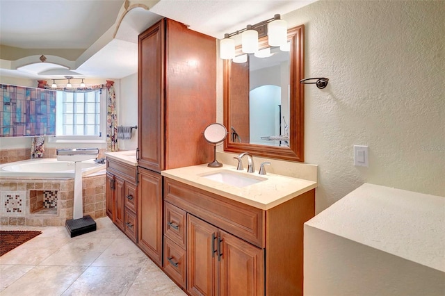 bathroom with tile patterned floors, tiled bath, and vanity