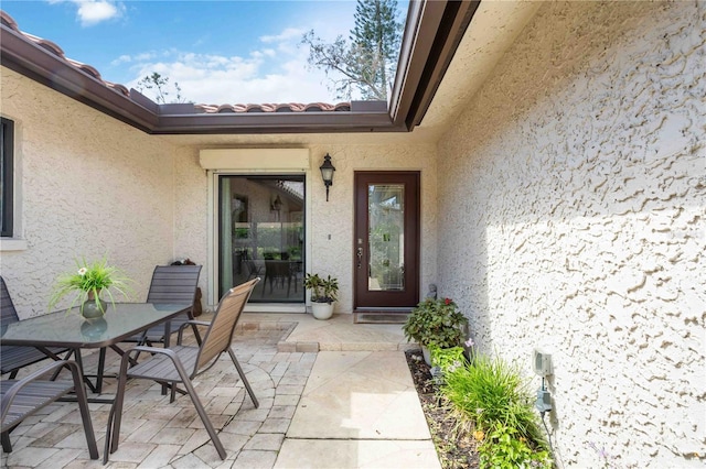 doorway to property with a patio area