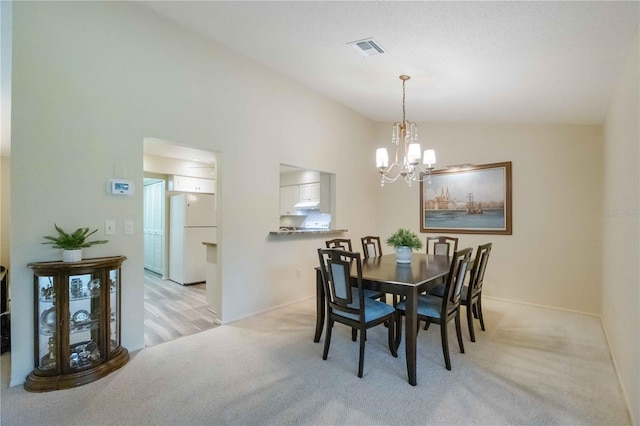 dining space featuring light carpet, lofted ceiling, and a notable chandelier