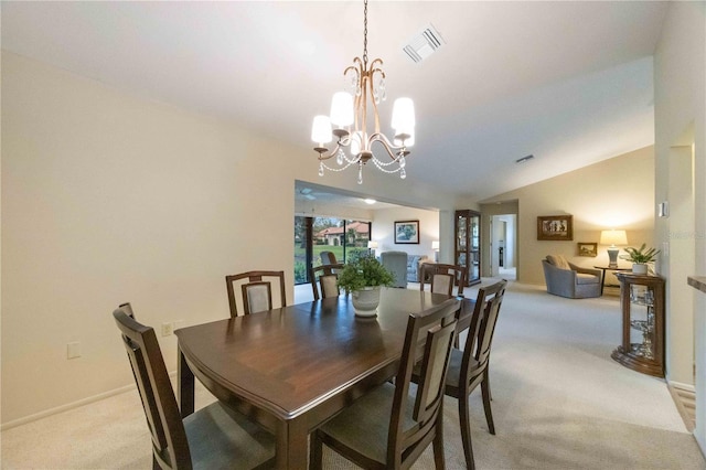 carpeted dining space with an inviting chandelier and lofted ceiling