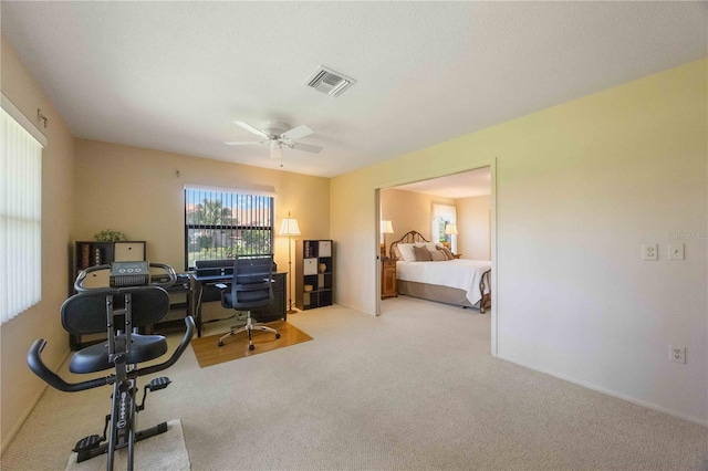 office area featuring light carpet and ceiling fan