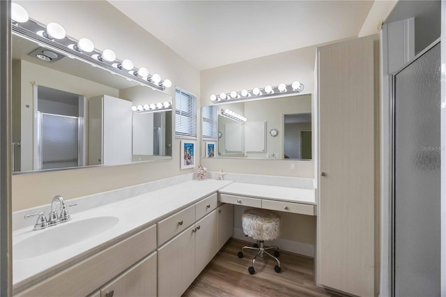 bathroom with vanity, an enclosed shower, and wood-type flooring