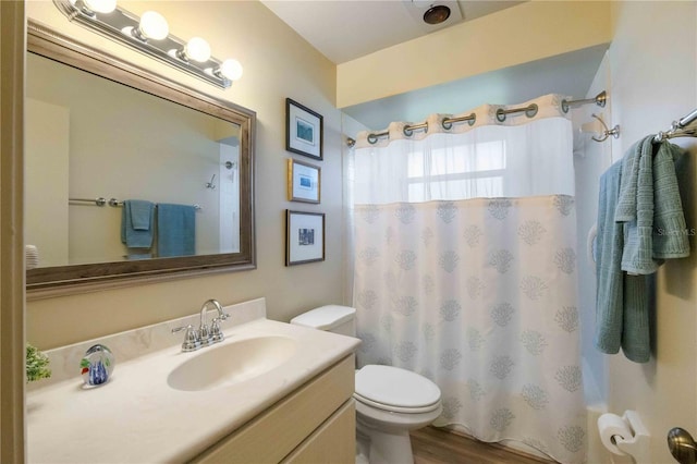 bathroom featuring wood-type flooring, vanity, and toilet