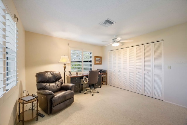 carpeted home office with ceiling fan