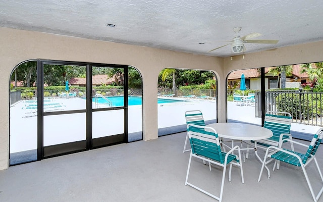 interior space with ceiling fan