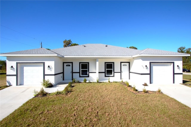 ranch-style house featuring a front lawn and a garage