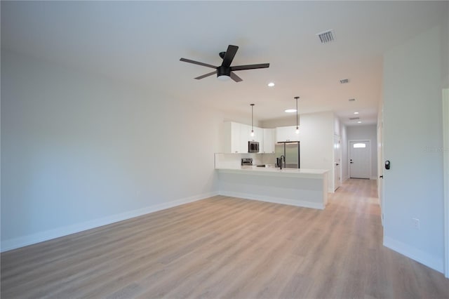 unfurnished living room with light wood-type flooring and ceiling fan