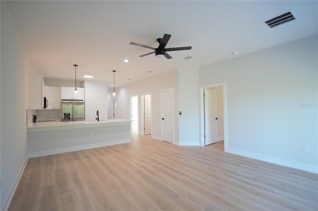 6779 David Blvd, Port Charlotte, FL 33981 - unfurnished living room featuring light wood finished floors, a ceiling fan, and recessed lighting