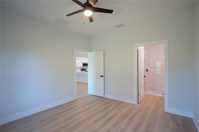 6779 David Blvd, Port Charlotte, FL 33981 - unfurnished bedroom featuring light wood finished floors, a ceiling fan, and connected bathroom