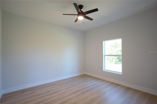 6779 David Blvd, Port Charlotte, FL 33981 - empty room with light wood finished floors and a ceiling fan