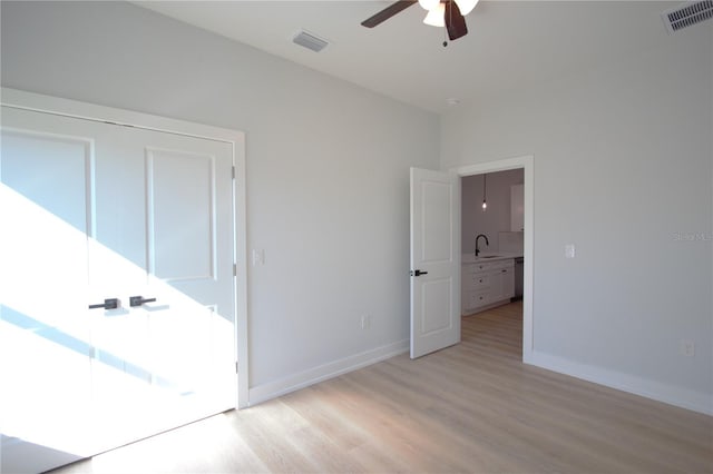 6779 David Blvd, Port Charlotte, FL 33981 - unfurnished bedroom with light wood finished floors and ceiling fan