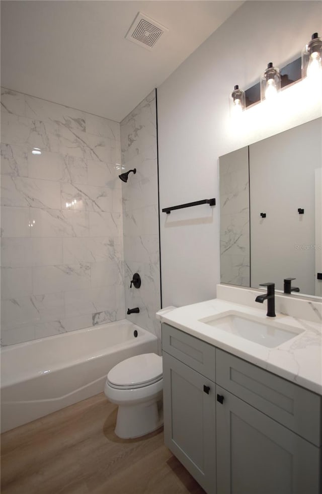 6779 David Blvd, Port Charlotte, FL 33981 - full bathroom with vanity, bathtub / shower combination, and wood finished floors