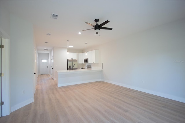 6779 David Blvd, Port Charlotte, FL 33981 - unfurnished living room featuring light wood-type flooring, ceiling fan, and recessed lighting