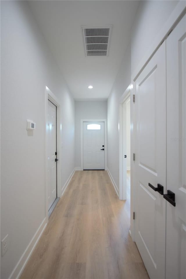 6779 David Blvd, Port Charlotte, FL 33981 - hallway with light wood-style floors and recessed lighting