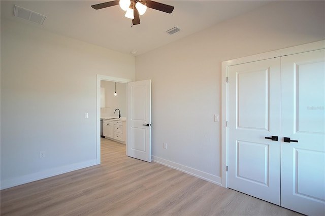 6779 David Blvd, Port Charlotte, FL 33981 - unfurnished bedroom featuring light wood-type flooring, a closet, and a ceiling fan