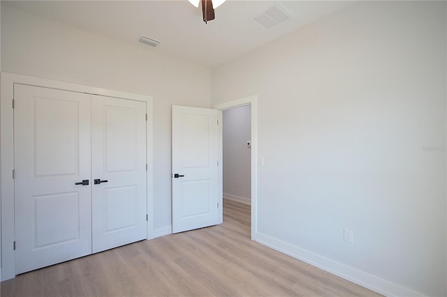 6779 David Blvd, Port Charlotte, FL 33981 - unfurnished bedroom featuring light wood finished floors, a closet, and a ceiling fan