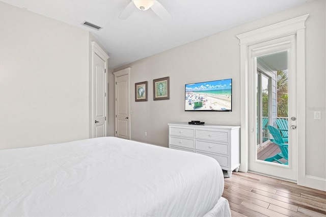 bedroom featuring ceiling fan, light hardwood / wood-style floors, and access to exterior