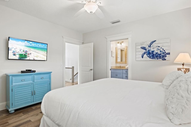 bedroom with ceiling fan, dark hardwood / wood-style flooring, and ensuite bathroom