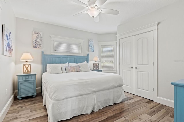 bedroom featuring ceiling fan, light hardwood / wood-style floors, and a closet