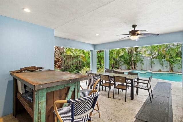 view of patio / terrace with a swimming pool with hot tub, an outdoor bar, and ceiling fan