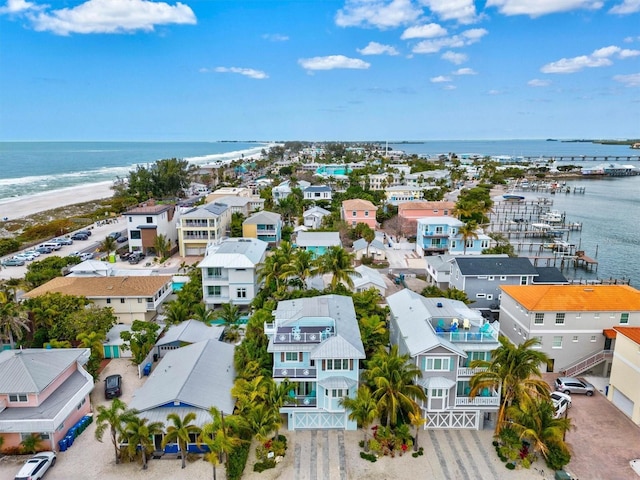 birds eye view of property featuring a water view and a beach view