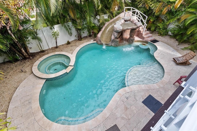 view of swimming pool with an in ground hot tub and pool water feature