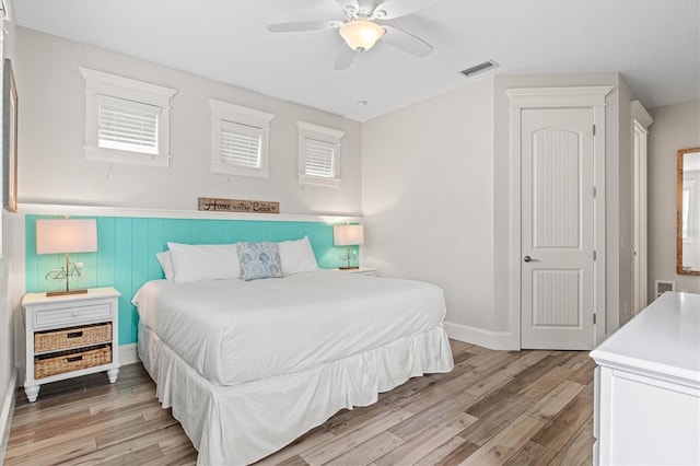 bedroom with ceiling fan and light hardwood / wood-style floors